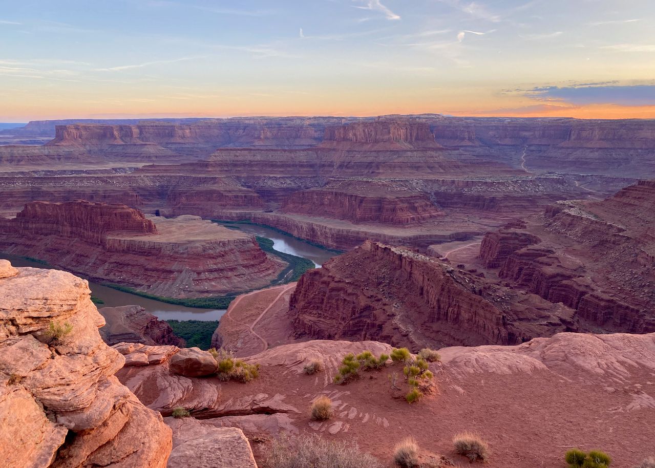 The Colorado River winding through the canyons of Canyonlands National Park at sunset, viewed from the rim