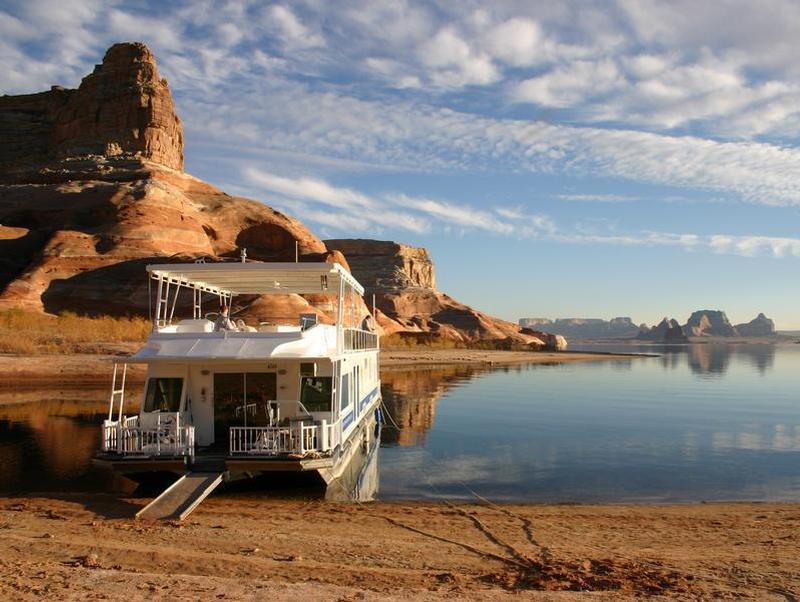 A houseboat beached on a sandstone shoreline of Lake Powell